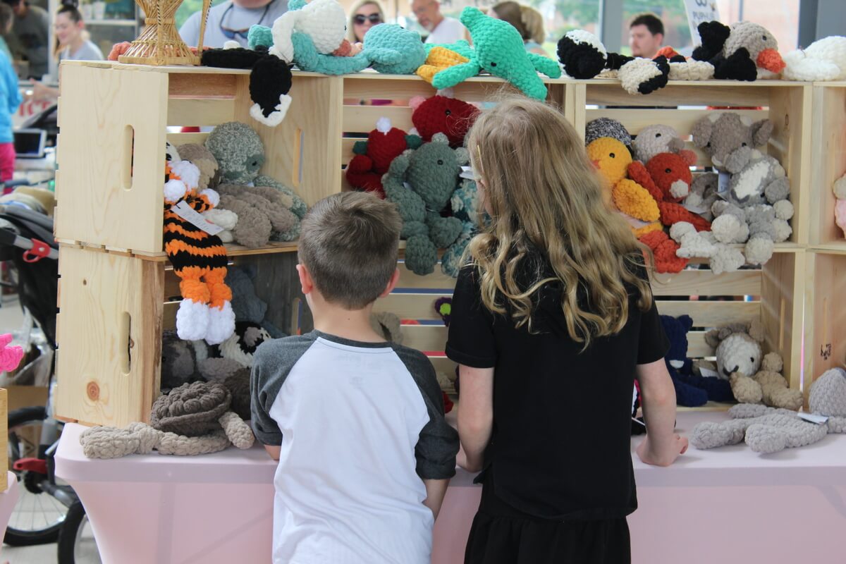 Kids browsing hand made toys